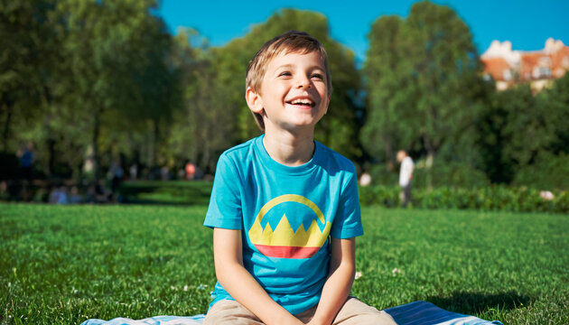 A heartwarming scene of a boy, dressed in a blue shirt, smiling brightly on a lush green lawn. The backdrop of a vibrant city park under clear skies adds to the charm of this delightful moment.