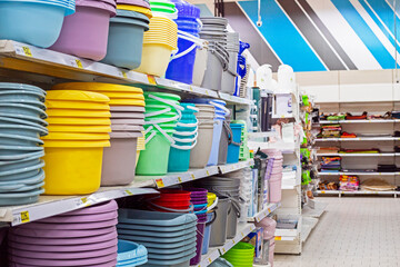 colorful plastic basins and buckets on the counter in a supermarket
