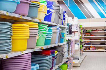 colorful plastic basins and buckets on the counter in a supermarket