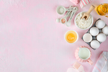 Baking ingredients and kitchen utensils on a pink background, top view.
