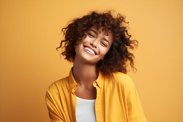 Smiling girl on yellow background