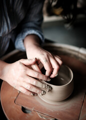 Unrecognizable Ceramics Maker working with Pottery Wheel in Cozy Workshop Makes a Future Vase or Mug, Creative People Handcraft Pottery Class