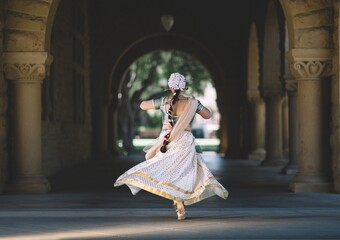 Indian girl in traditional costume is dancing
