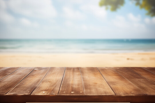 The empty wood table top with a blurred background of a sand beach