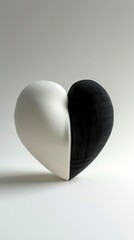 still life photo of a heart made of fabric half white and half black, on a white background