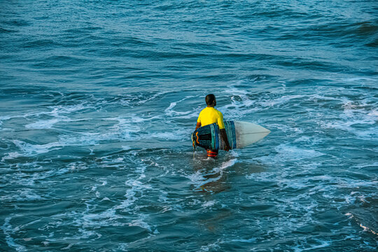 Extreme Fast Action Sports or Highspeed Action Photography or High Shutterspeed Photography - Picture of Surfer Man Surfing On Blue Ocean Wave, Kovalam Beach, Chennai, Tamilnadu, South India.