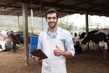 agriculture industry, dairy farming, livestock and animal husbandry concept. Dairy farmer male at...