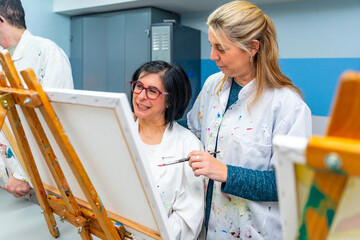 Teacher and woman with special needs in an art class