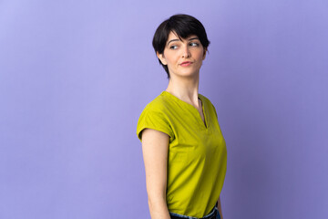 Woman with short hair isolated on purple background . Portrait