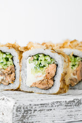 Close-up of sushi rolls made of sausage and covered with cabbage and ketchup. Homemade asian style. Sushi-food hybrids trend. Japanese food