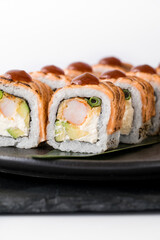 Close-up of sushi rolls made of sausage and covered with cabbage and ketchup. Homemade asian style. Sushi-food hybrids trend. Japanese food