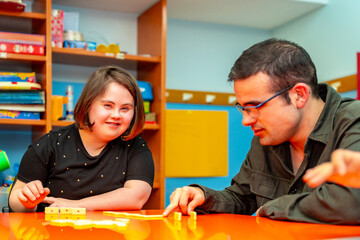 People with special needs playing board skill games