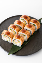 Close-up of sushi rolls made of sausage and covered with cabbage and ketchup. Homemade asian style. Sushi-food hybrids trend. Japanese food