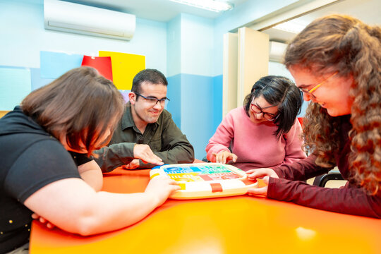Group of disabled people playing board games together