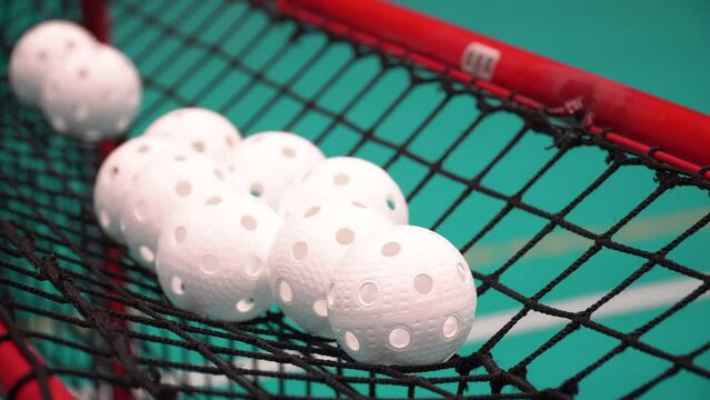 Floorball balls on top of goals during warm-up session