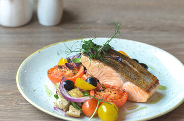 grilled salmon steak with vegetables on a plate
