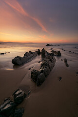 Vertical view at sunset of the flysch of Barrika beach, Bizkaia, with a lot of sand between the...