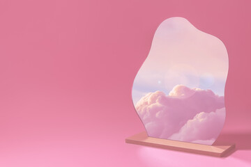creative composition. mirror on pink background, clouds are reflected in the mirror at sunset
