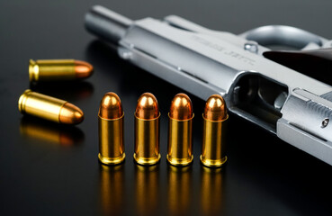 Bullet compartment and ammunition put on a black desk with blurred short pistol background, Gun isolated method, pistol checking, cleaning, maintenance or services.
