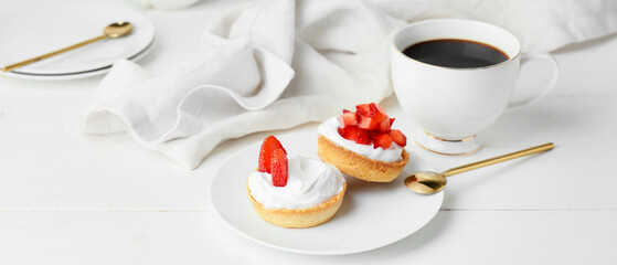 Plate with tasty tartlets and cup of coffee on white table - obrazy, fototapety, plakaty