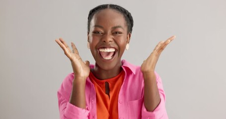Excited, black woman and surprise with good news for winning, celebration or prize on a gray studio background. Portrait of African female person with smile for lucky draw or lottery on mockup space