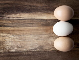 Eggs on wooden empty space background.