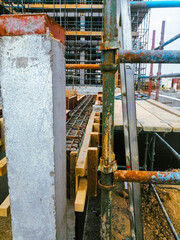 Naklejka premium A construction site with scaffolding and pipes. Scene is one of progress and hard work
