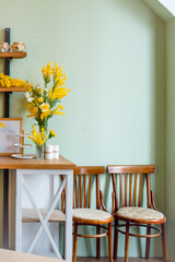 Yellow spring flowers in living room interior
