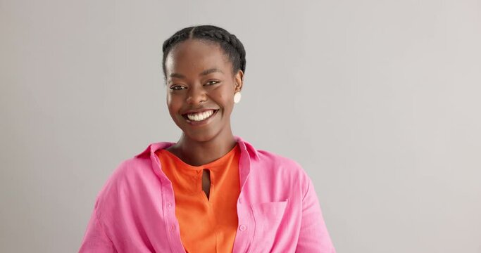 Black woman, studio and portrait with smile with happiness for thank you, compliment or confident on grey background. African person, face and expression with satisfaction for joy, pride and surprise