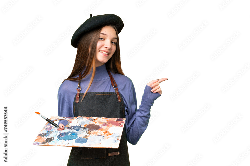 Poster Young artist man holding a palette over isolated chroma key background pointing finger to the side