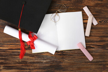 Mortar board with diploma, book and eyeglasses on wooden background