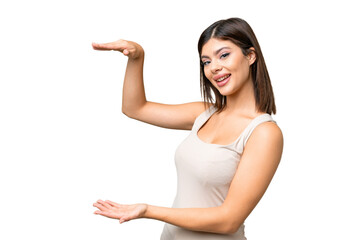 Young Russian woman over isolated chroma key background holding copyspace to insert an ad