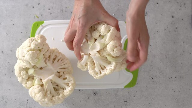 The chef devided cauliflower into florets, the cooking process, view from above. 