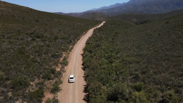 Driving with the white car at the South African gravel roads