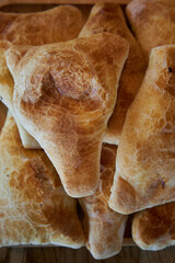Delicious Asian food, Traditional eastern cuisine Tajikistan, Uzbekistan, Kyrgyzstan, Kazakhstan. Triangular puff pastry samosas. Fresh baked goods: samsa with meat or potato close up, top view. 