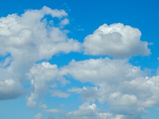Naklejka na ściany i meble Blue sky background with fluffy white clouds, perfect for nature and outdoor-themed designs