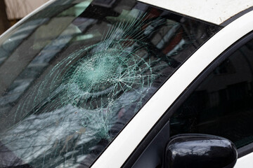 Broken car windshield, close up. Car crash accident, damaged windscreen