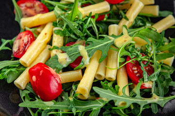 pasta salad tomato, arugula, boiled pasta fresh food tasty healthy eating cooking appetizer meal food snack on the table copy space food