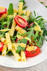 pasta salad tomato, arugula, boiled pasta fresh food tasty healthy eating cooking appetizer meal food snack on the table copy space food