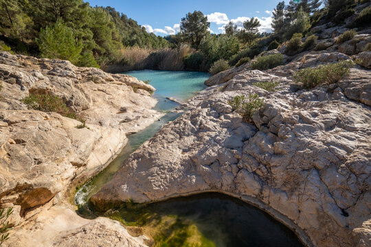 Horizontal photo of the source of Fuente Caputa, between rocks, in the town of Mula, Region of Murcia, Spain, between rocks and on a sunny day