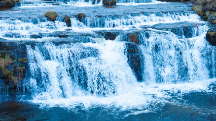 Guarguero waterfalls in winter around the port of Estacas de Trueba. Aerial view from a drone....