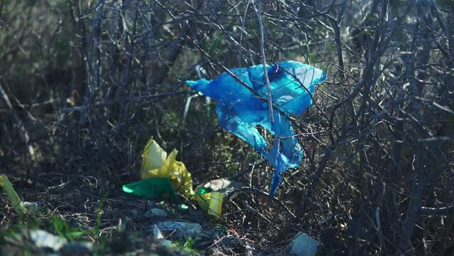 Pile of garbage on green grass in the nature environment problems. Nature protection. Environment pollution concept