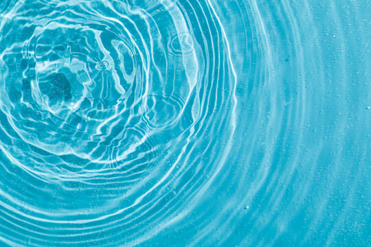 drops on water with circles on a blue background