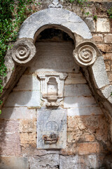 Old ottoman fountain of the late 18th century, with religious writings in ottoman alphabet, in the old town of Nafplio, in Peloponnese region, Greece, Europe. 