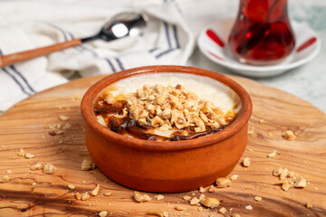 Rice pudding dessert. Milky dessert. Oven rice pudding on gray background. Local name sütlaç