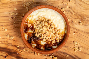 Rice pudding dessert. Milky dessert. Oven rice pudding on gray background. Local name sütlaç