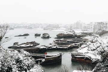 View over the city of Biarritz with the Fishermen Port covered with snow. Basque Country of France....