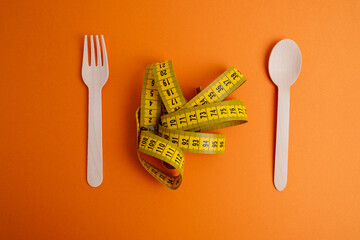 Yellow measuring tape on a light background. Tool for measuring length and volume. Tape for...