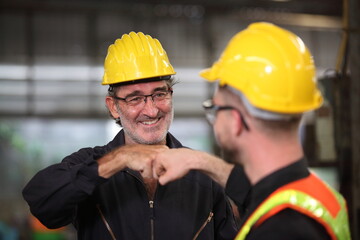 worker or engineer working in factory with safety uniform , safety hat and safety glasses , image is safety concept or happy workplace