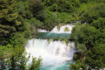 cascade waterfall among large stones in Krka Landscape Park, Cro